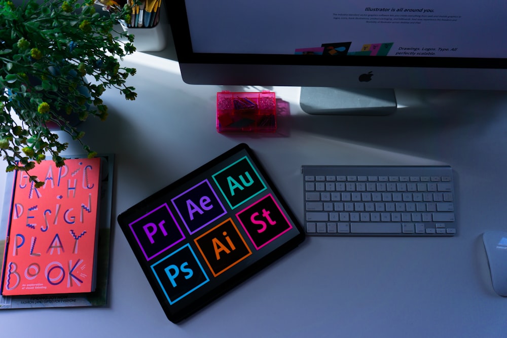 A designer's bright workspace with brand graphics on screen